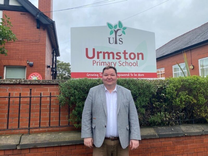 Andrew, pictured outside Urmston Primary School, during a recent visit. 