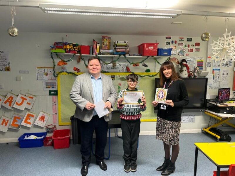 Andrew, with Kamran, the winner of his Christmas card design competition and Sally Judge, the headteacher of Delamere School.