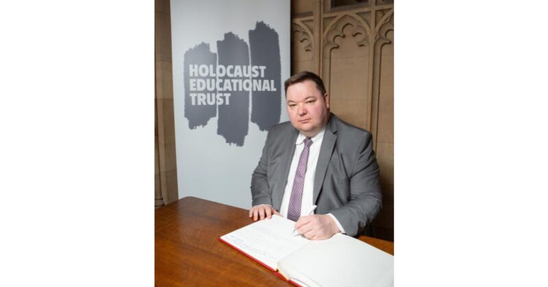 Andrew Western - signing the Holocaust Educational Trust Book of Commitment.